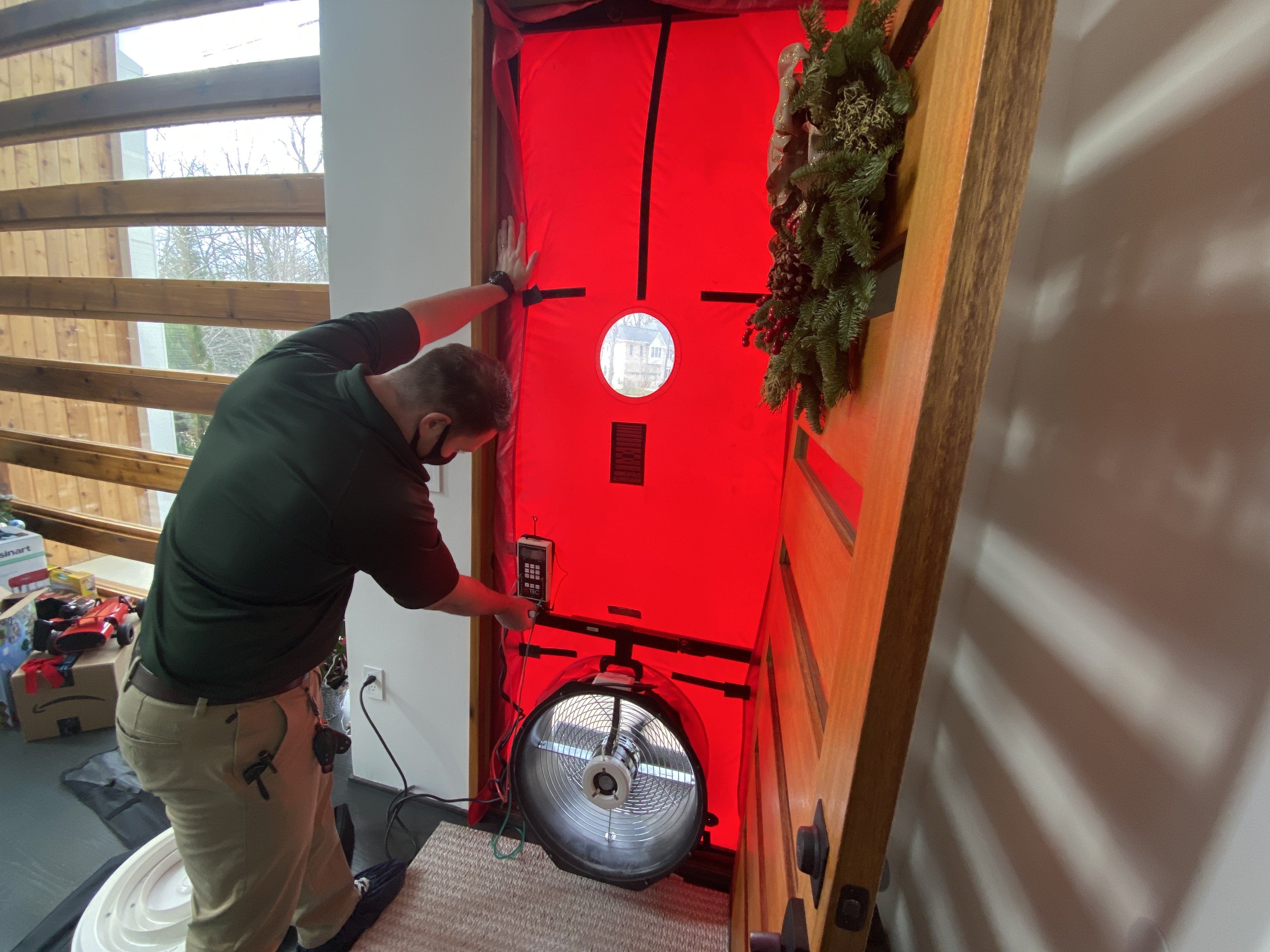 home energy medics technician doing blower door test