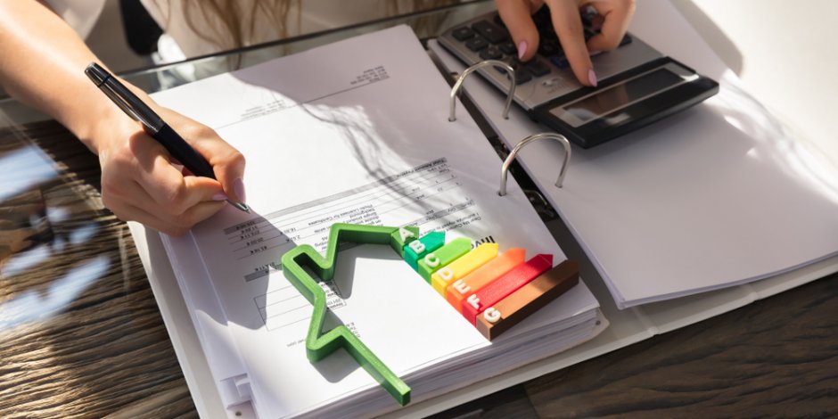 woman finishing an energy audit report for homeowners