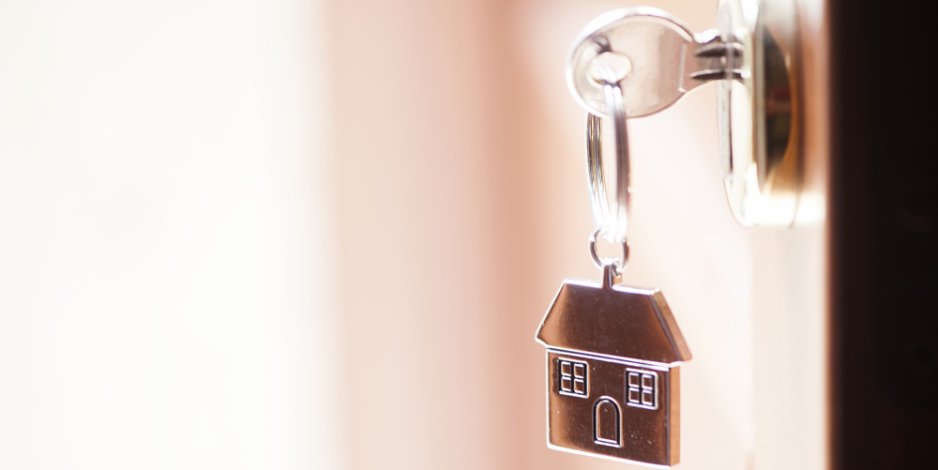 home keychain attached to a key that's in a door lock